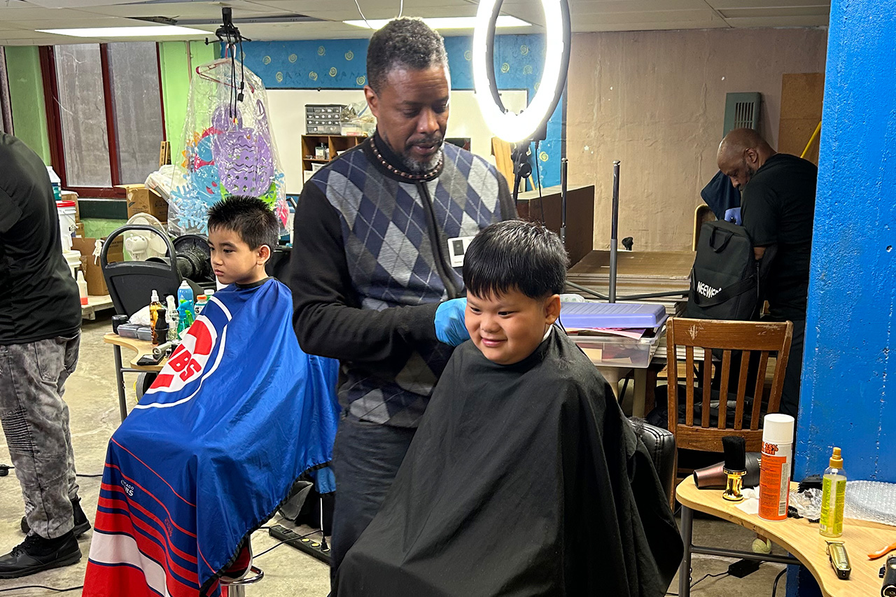 man-giving-a-young-boy-a-haircut
