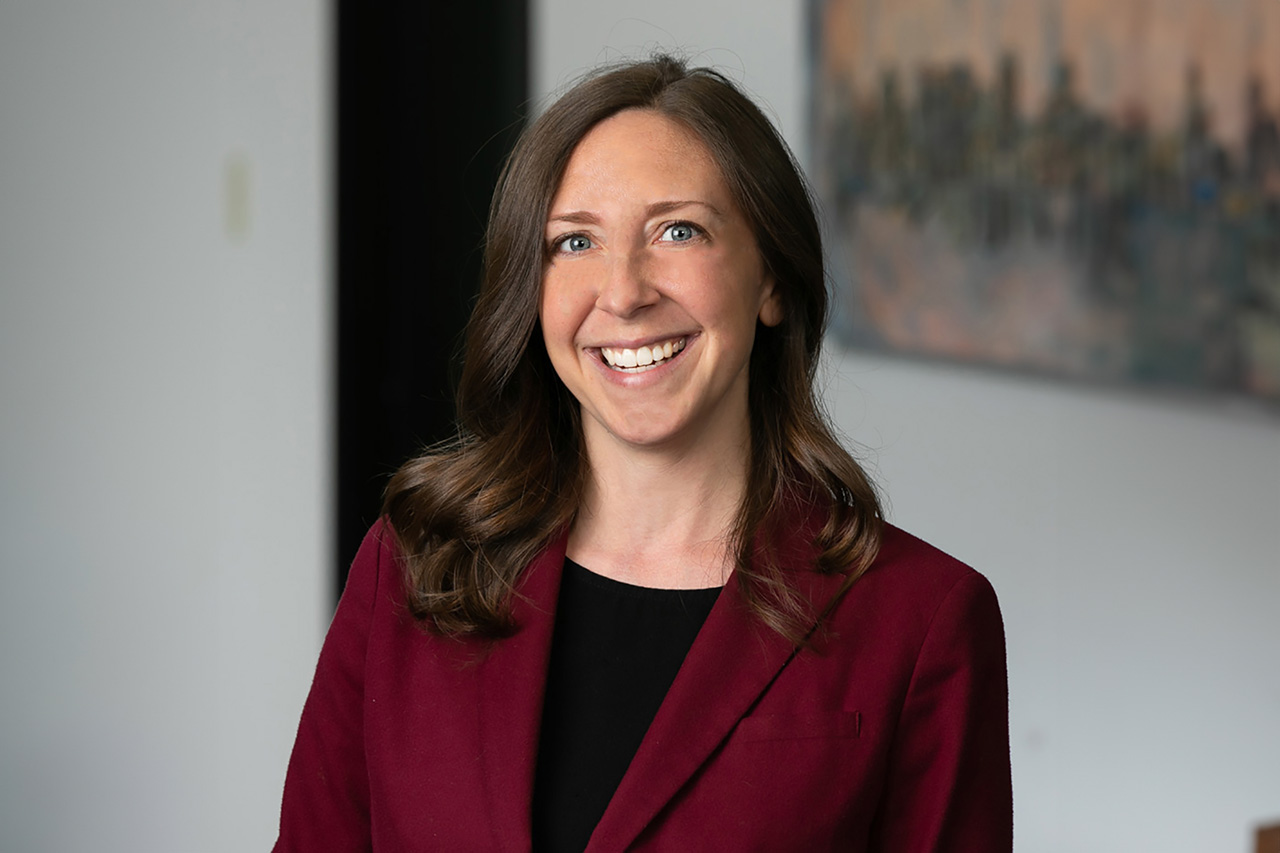 Woman-wearing-a-maroon-colored-blazer-smiling