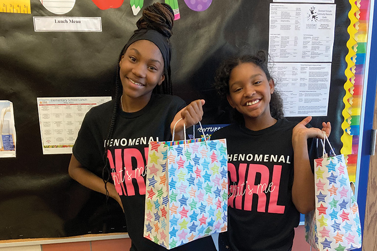 two-african-american-girls-holding-bags