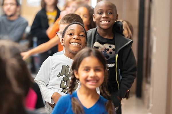 group-of-elementary-age-kids-standing-in-a-line-at-school
