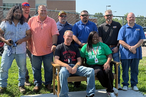 Group-of-union-workers-standing-together-by-a-bench