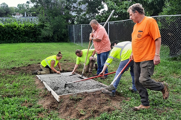 group-of-workers-pouring-and-spreading-cement