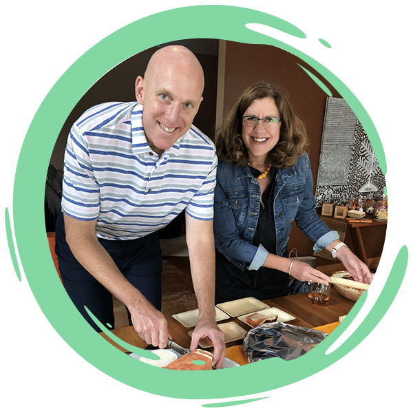 man and women preparing food in their home