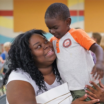 woman-holding-her-son-smiling
