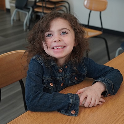 young-girl-smiling-in-a-classroom