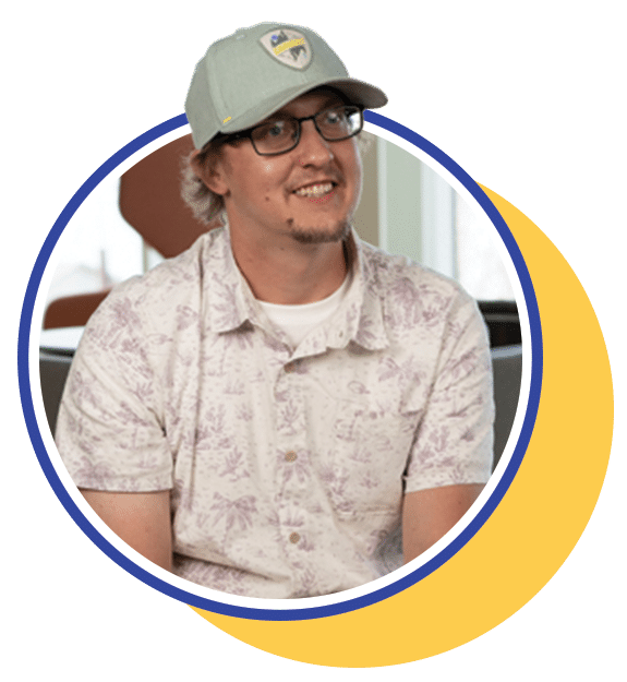 White male with a hat sitting in a lobby