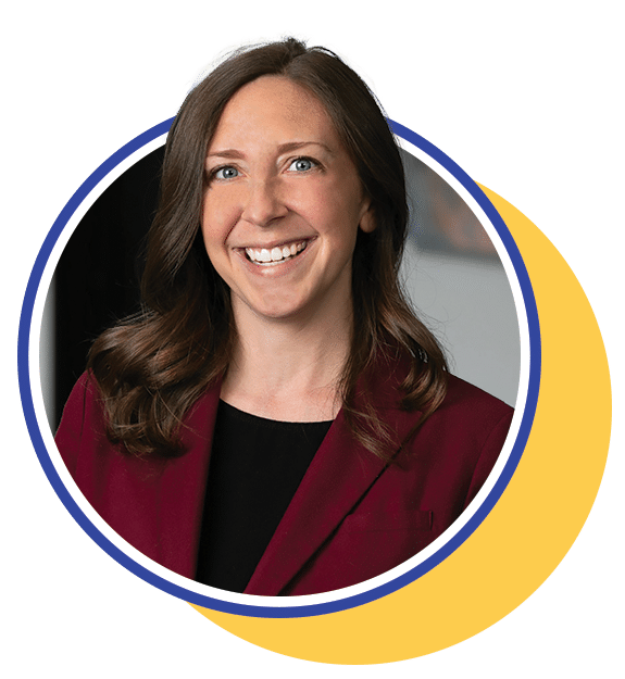 woman in a maroon blazer smiling