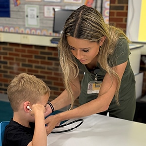 nurse-showing-a-stethoscope-to-a-child