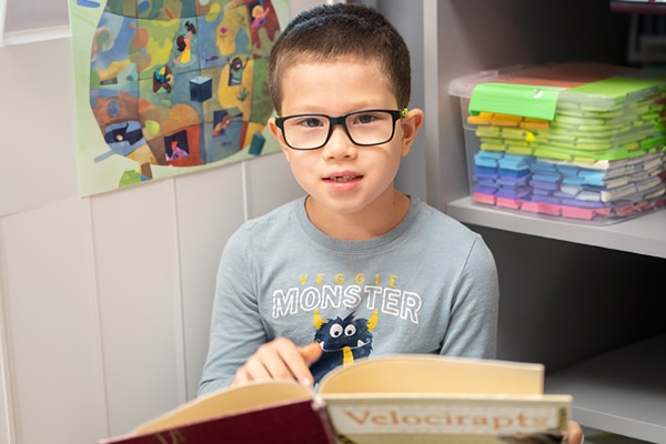 young-boy-with-glasses-holding-a-book