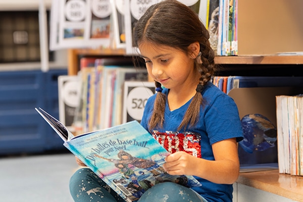young-girl-sitting-down-reading-a-book