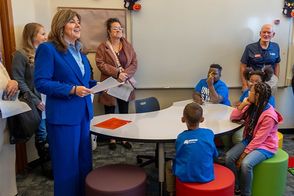 adults interacting with kids in a classroom