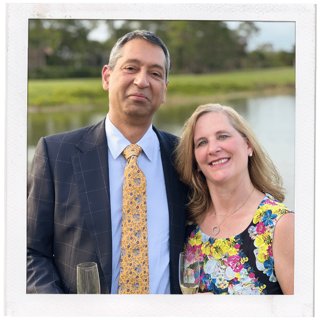 a man and a woman dressed nicely outside holding wine glasses